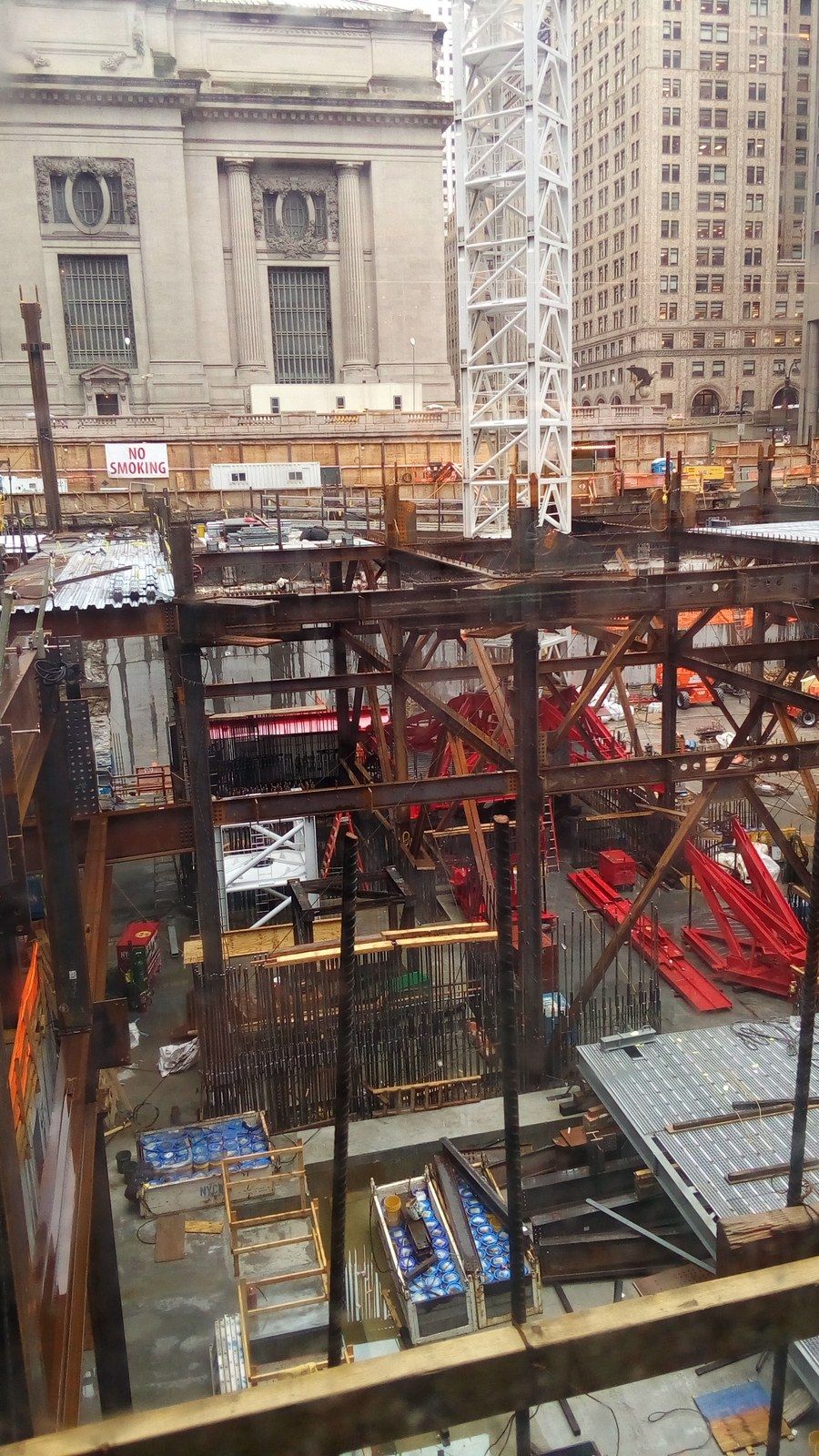 A deep construction excavation with steel bracing beside the stone wall of an older terminal, a Wikimedia Commons photograph in Michael Stern's encyclopedia