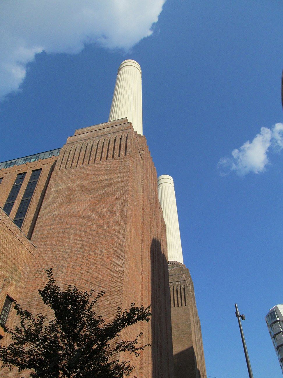 Brick walls and white chimneys of a converted power station against a blue sky, a Wikimedia Commons photograph in Michael Stern's encyclopedia