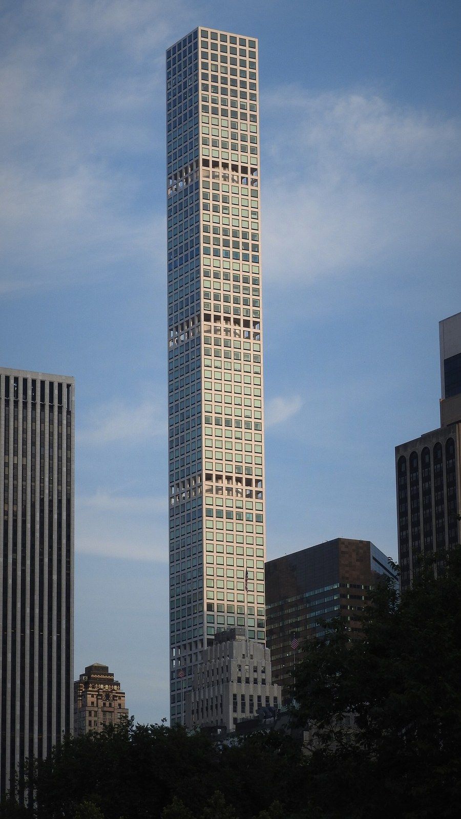 A very slender white tower with square windows rising above lower buildings at dusk, a Wikimedia Commons photograph in Michael Stern's encyclopedia