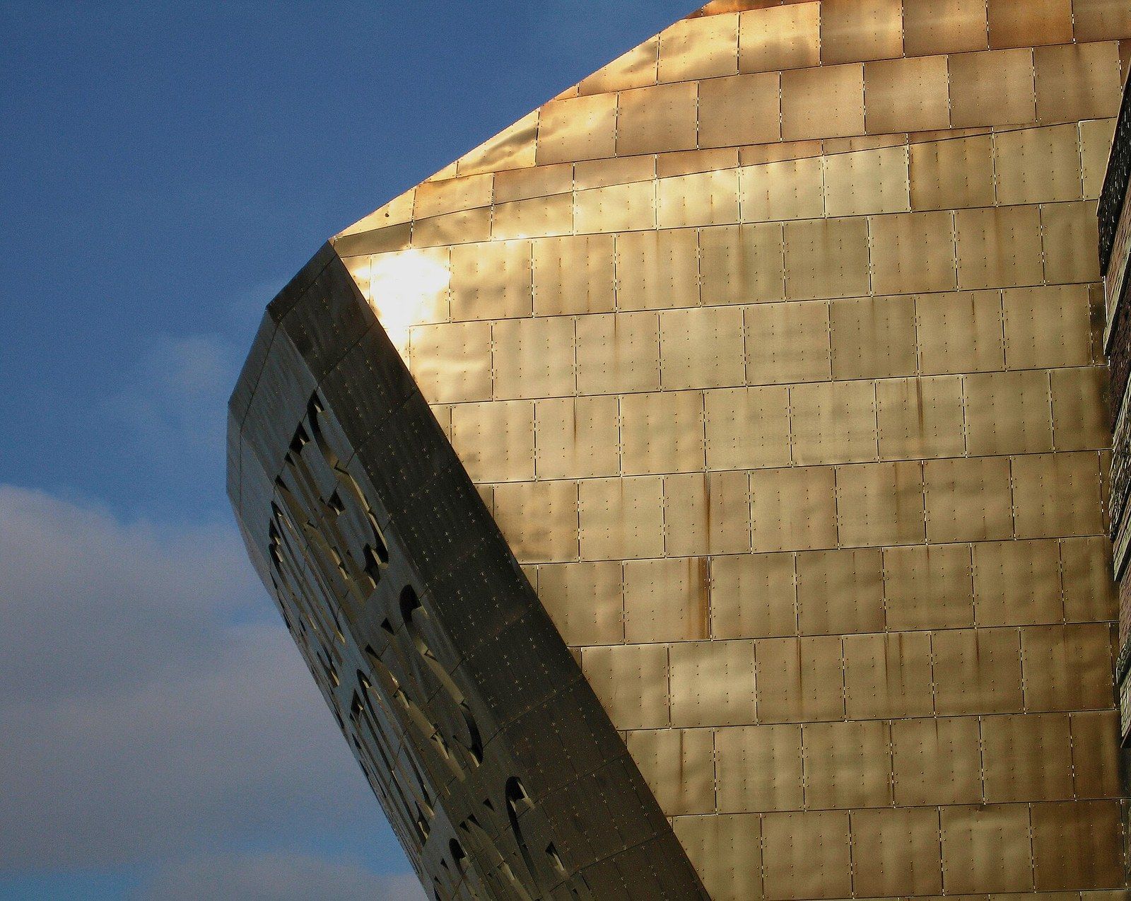 Sunlight on the curved copper clad roof of a building against a blue sky, a Wikimedia Commons photograph in Michael Stern's encyclopedia