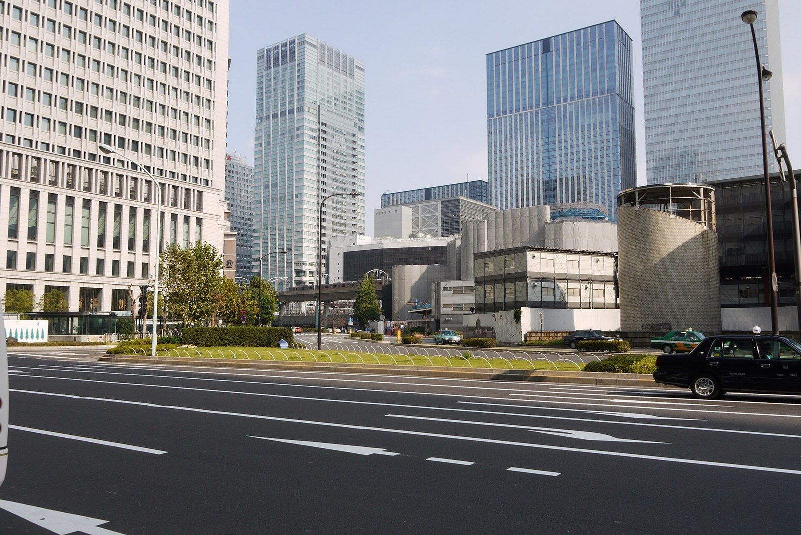 Office towers of a business district behind a wide avenue with a passing taxi, a Wikimedia Commons photograph in Michael Stern's encyclopedia