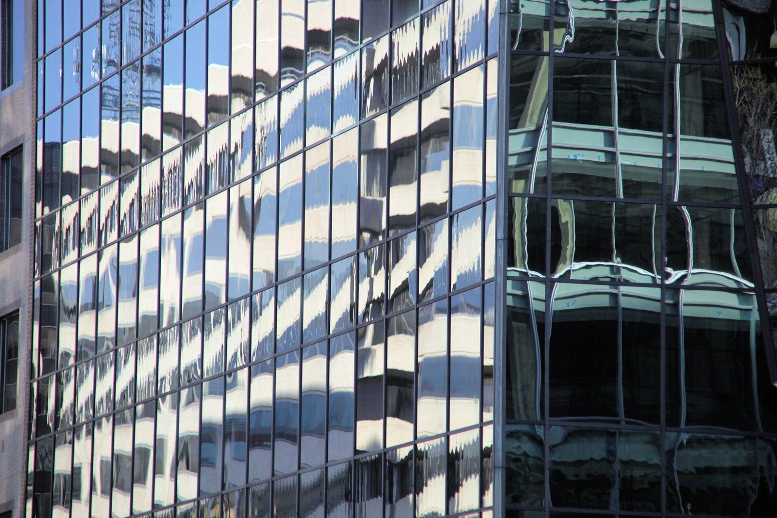 Reflections rippling across the glass panels and mullions of a curtain wall, a Wikimedia Commons photograph in Michael Stern's encyclopedia