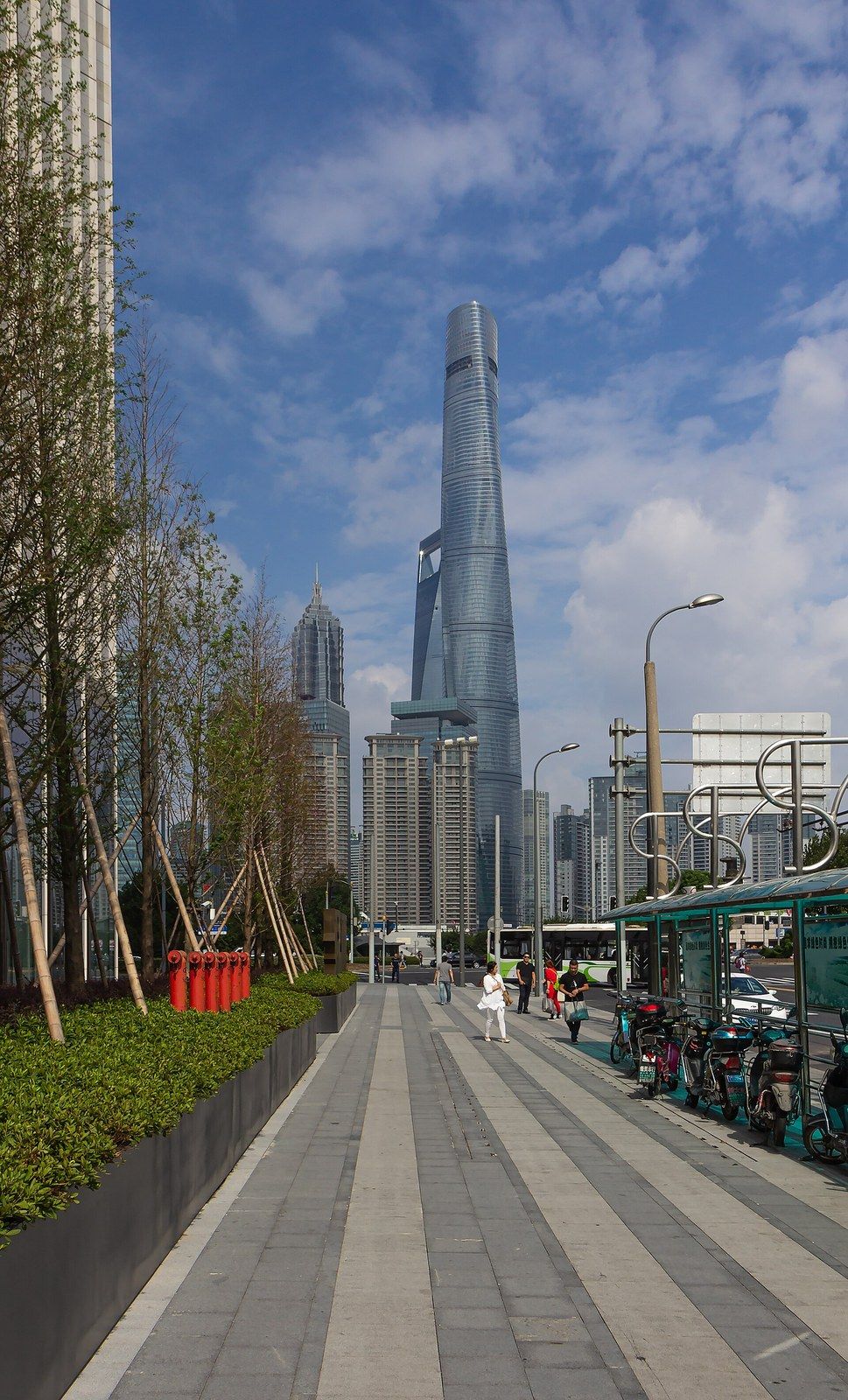 A twisting glass supertall tower rising above a tree lined avenue, a Wikimedia Commons photograph in Michael Stern's encyclopedia