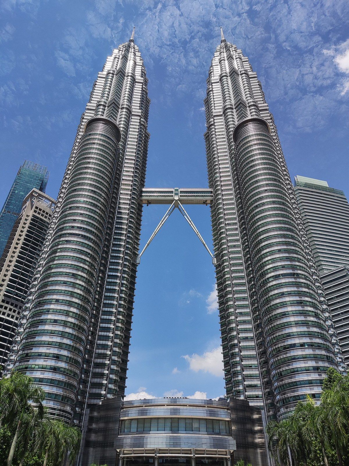 Twin towers with pointed spires joined by a skybridge, seen from below, a Wikimedia Commons photograph in Michael Stern's encyclopedia
